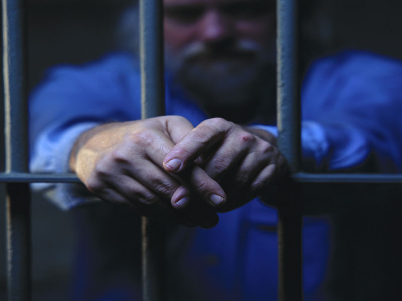 prisoner behind the bars